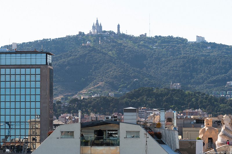 20160529_182334 D4S.jpg - Tibidabo is a mountain overlooking Barcelona, Catalonia, Spain. At 512 metres (1,680 ft), it is the tallest mountain in the Serra de Collserola. Rising sharply to the north-west, it affords spectacular views over the city and the surrounding coastline. The summit of the mountain is occupied by the Sagrat Cor church